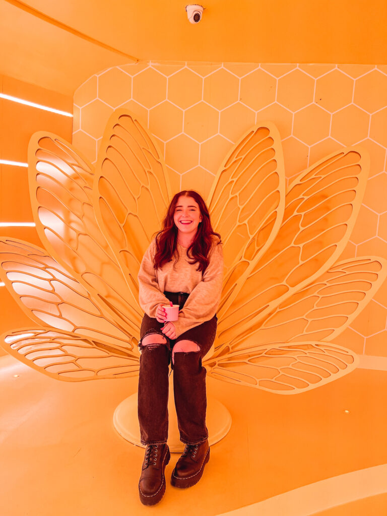 Museum of Ice Cream yellow butterfly chair with girl sitting on it.